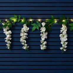 Mason & Jones - Solar Specialists Solar Powered 180cm Artificial Leaf Garland With Wisteria Flowers - Warm White -Garden Furniture Shop 379258 180cm solar powered artificial leaf garland with wisteria flowers 20 warm white micro leds 3